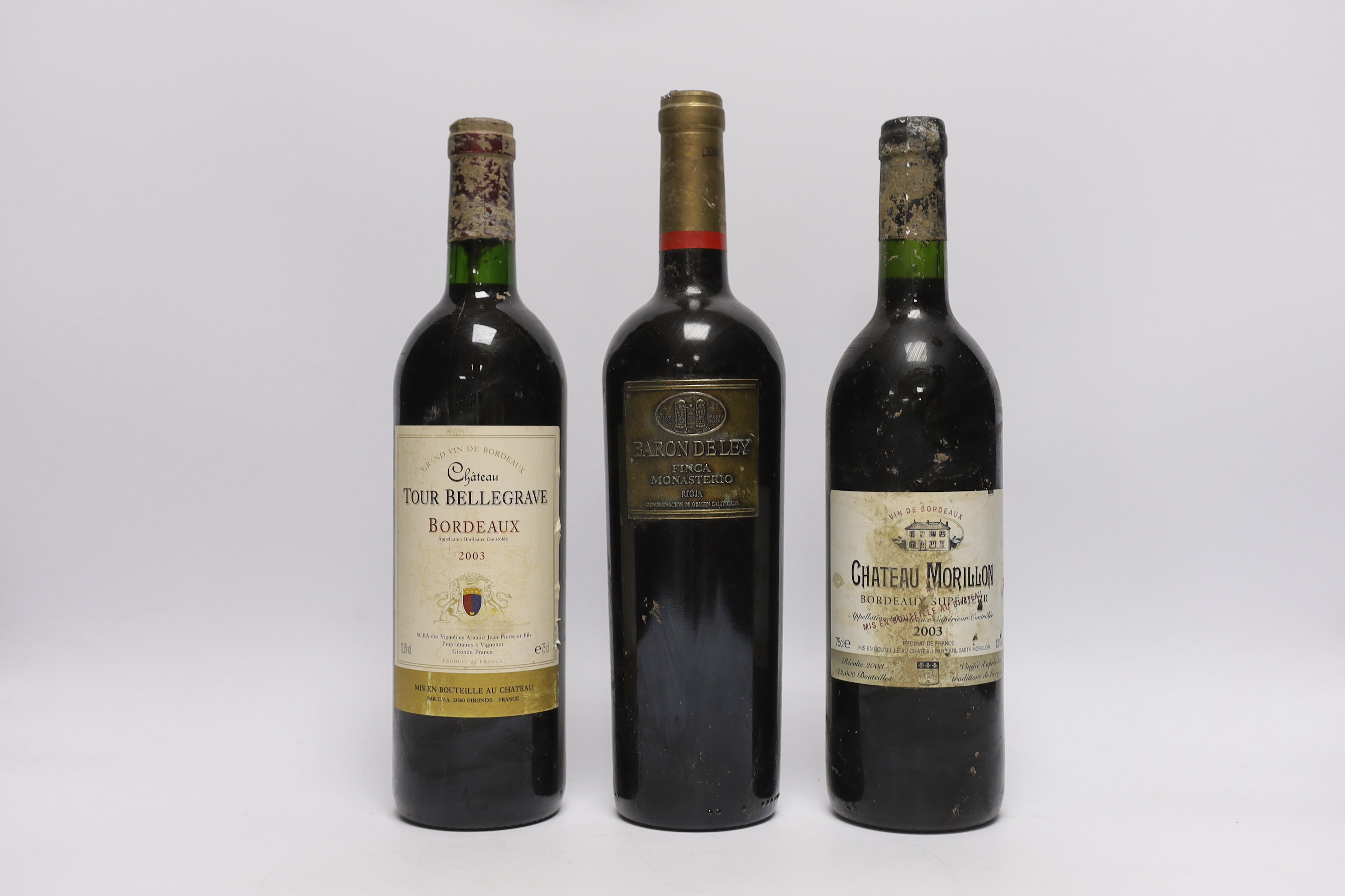 Six bottles of red wine - two bottles of Chateau Tour Bellegrave 2003, a bottle of Baron De Ley Rioja, a bottle of Simon Bize Aloxe Corton Le Suchot 2003, a bottle of Gérard Thomas Puligny-Montrachet La Garenne 2003 and